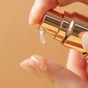 Up close product shot of a person pumping ma:nyo's Bifida Biome Concentrate Serum on their finger tip.