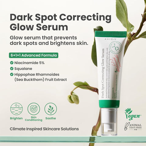 AXIS-Y Dark Spot Correcting Glow Serum product tube displayed with plant background. Text highlights benefits: glow serum that prevents dark spots and brightens skin. Key ingredients include Niacinamide 5%, Squalane, and Sea Buckthorn Fruit Extract. Features icons for Brighten, Skin Conditioning, and Soothe. Vegan and cruelty-free skincare solution.