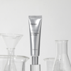 ma:nyo's 4GF Ampoule Eye Cream in the center with laboratory flasks behind the product.  